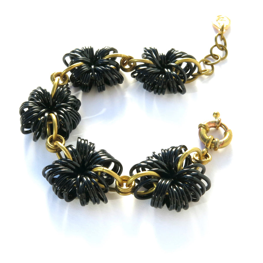 The Allegory Bracelet is made with 5 whimsical clusters bursting with shiny black loops. Made by MoonRox Jewellery & Accessories in Toronto, Canada.