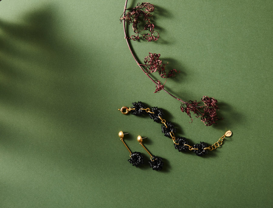 The Allegory Bracelet and Stud Earrings with whimsical clusters bursting with shiny black loops. Made by MoonRox Jewellery & Accessories in Toronto, Canada.