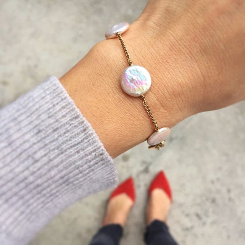 Dot to Dot Pearl Bracelet by MoonRox Jewellery & Accessories features freshwater pearl discs in Cloud spaced along fine chain. Shown worn on wrist.