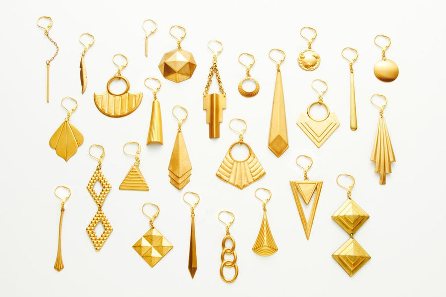 Layout of many brass earrings from MoonRox Jewellery & Accessories - made in Toronto, Canada (Photography by Joseph Saraceno)