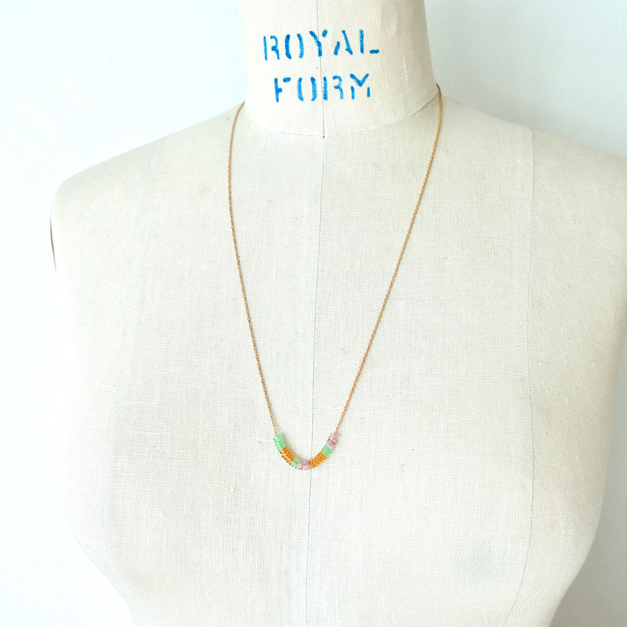 Inner Circle Necklace features a fine brass chain with a carefully arranged series of little colourful glass loops that float along the chain. Made in Toronto, Canada by MoonRox Jewellery & Accessories.