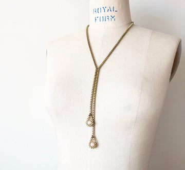 Lustrous Necklace by MoonRox is a Y-style necklace featuring vintage glass pearls bound by brass box chain.