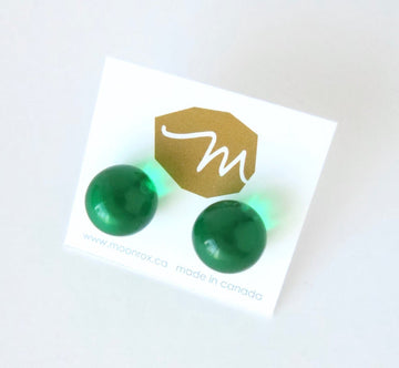 Orb Stud Earrings by MoonRox are large spherical transparent acrylic stud earrings in glowing emerald green.