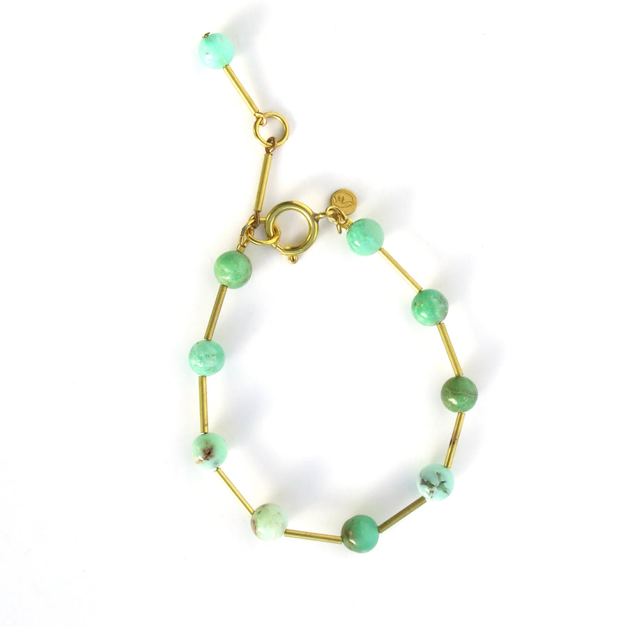 Resilience Bracelet made of round semi-precious stones staggered with brass tubes. Shown in chrysoprase.