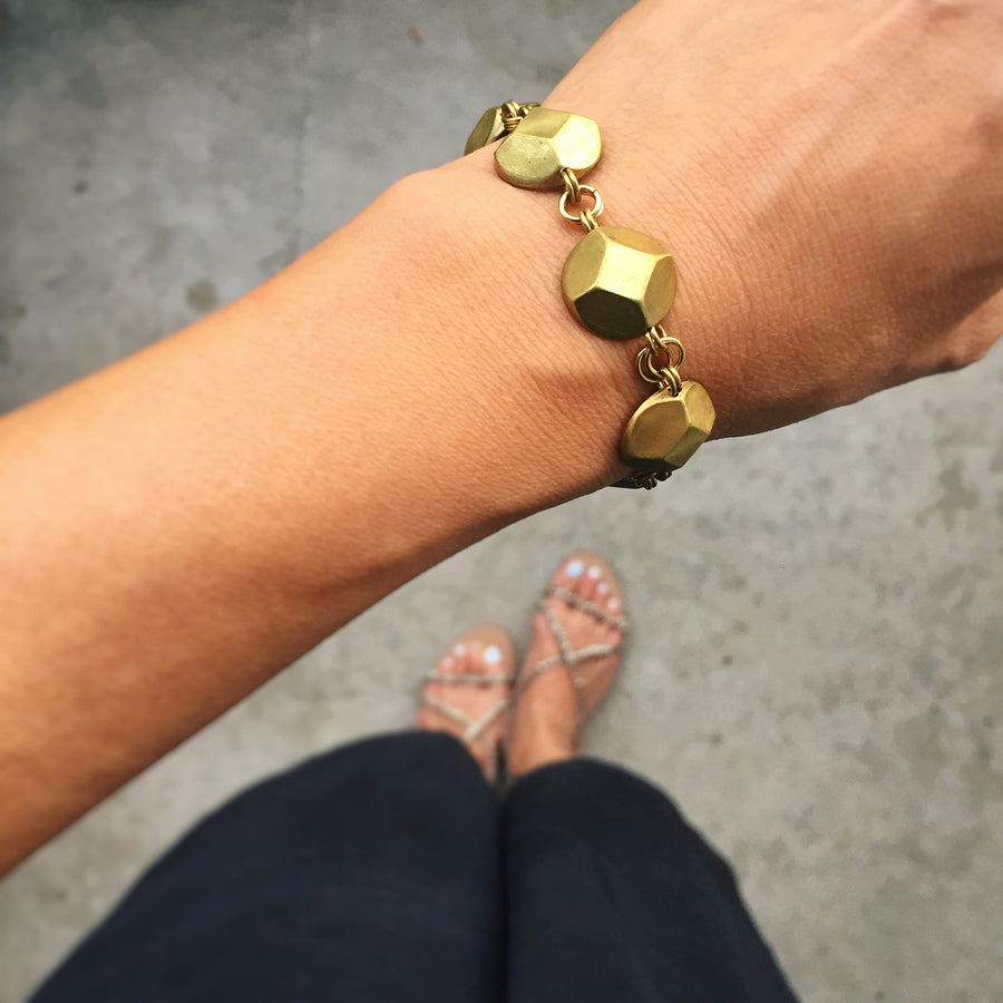 Reverie Bracelet by MoonRox Jewellery & Accessories shown on wrist. This elegant bracelet features faceted brass jewel shapes.