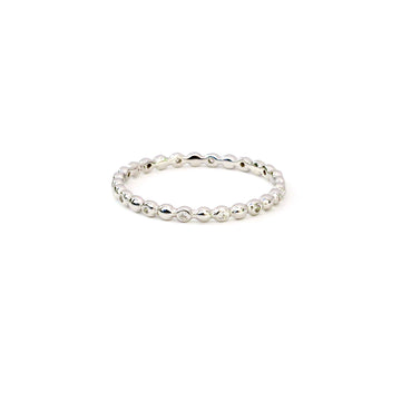 Seed Ring is a sterling silver ring with a row of little pods and cubic zirconia stones along the band.