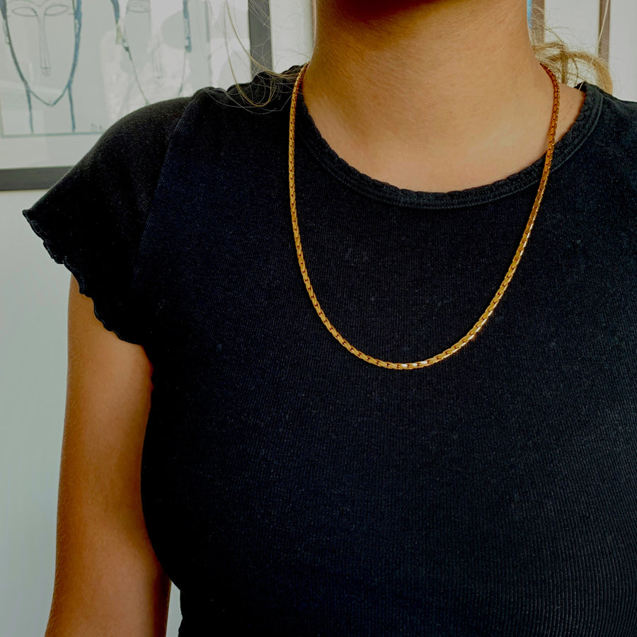 Winding River Chain Necklace is a classic vintage brass necklace. Shown on model.