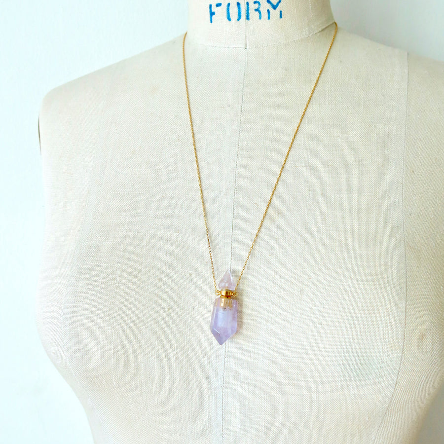 Aroma Necklace by MoonRox Jewellery & Accessories features pendant that is a small functioning bottle made of semi-precious stone. Shown in amethyst.
