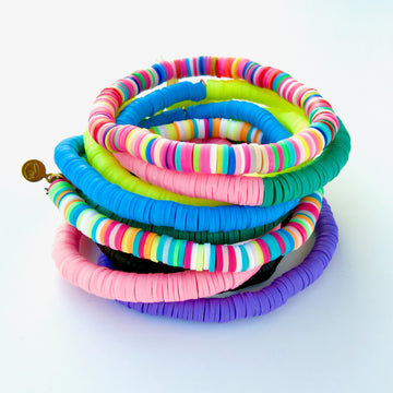 Colourful stack of rubber paillette Confetti Bracelets . Bracelets stretch to fit all sizes.