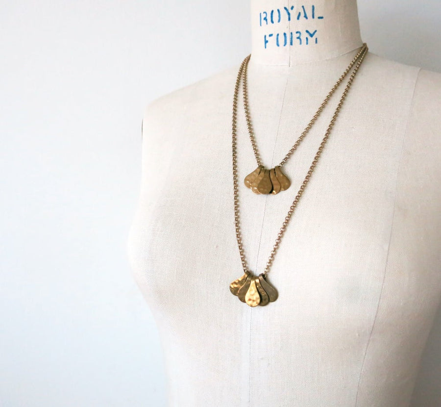 Fragment Necklace with five pieces that work together to form a pendant. The pieces slide freely along a brass chain. Available in two lengths.