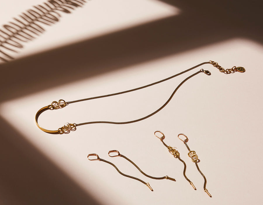 Splendere Earrings by MoonRox are long dangly chain earring made of brass. Shown in Lookbook image with Frizzante Necklace and Earrings. Jewelry made in Toronto, Canada.