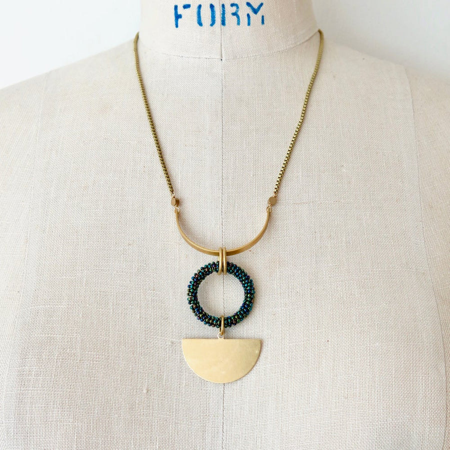 Halo Necklace by MoonRox Jewellery & Accessories features geometric brass forms surrounding a carefully hand beaded loop.