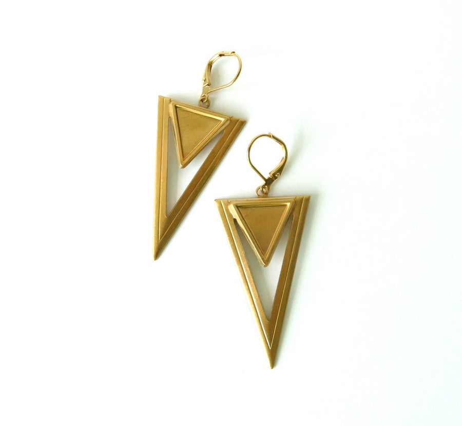 Steeple Earrings are architectural brass forms. Downward pointing triangular brass charms hang from lever back ear wires.