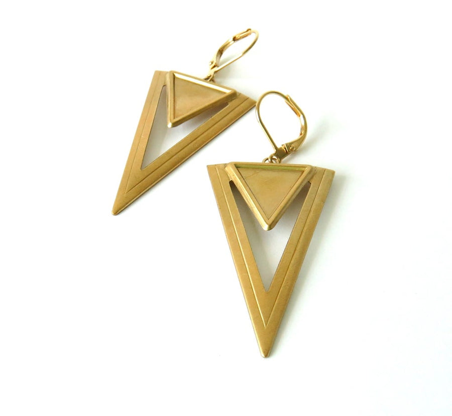 Steeple Earrings are architectural brass forms. Downward pointing triangular brass charms hang from lever back ear wires.