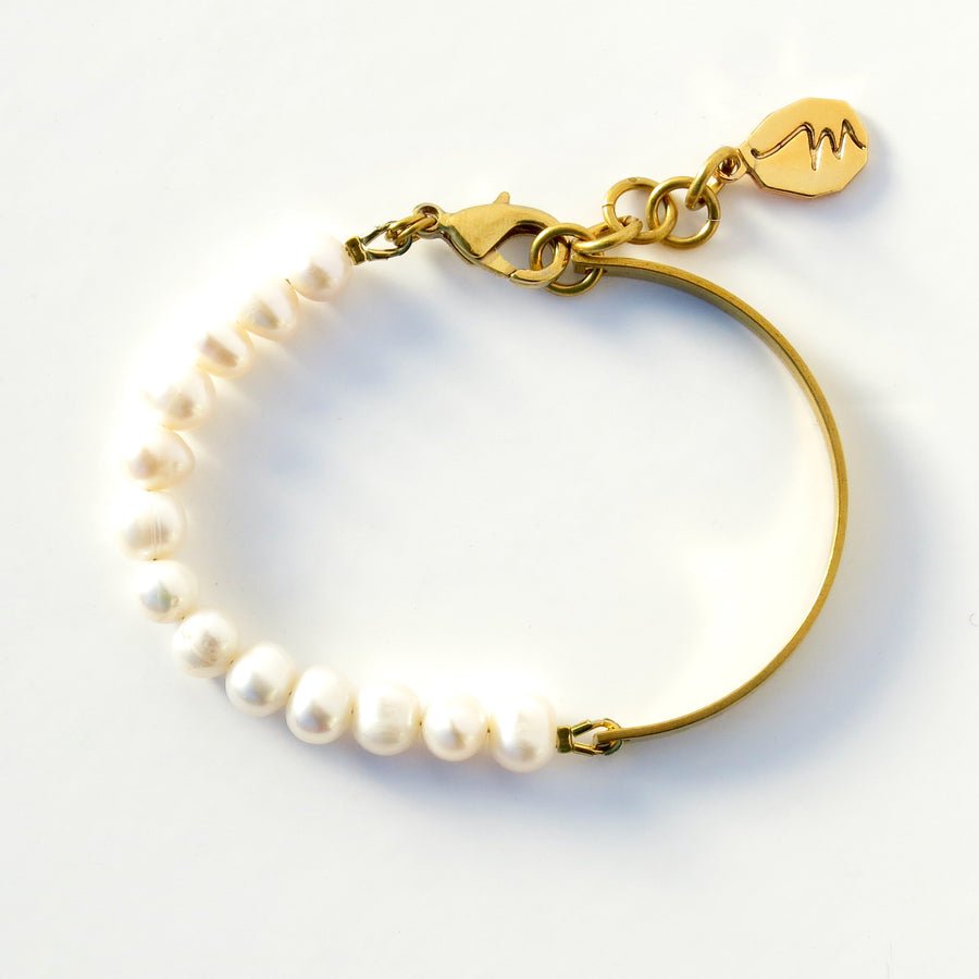 Illuminated Bracelet by MoonRox - bracelet with one half consisting of a string of freshwater pearls and the other half a solid brass band. 