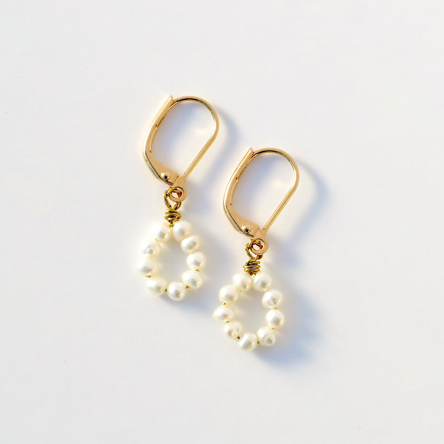 The Illuminated Earrings feature hand wired freshwater pearls.