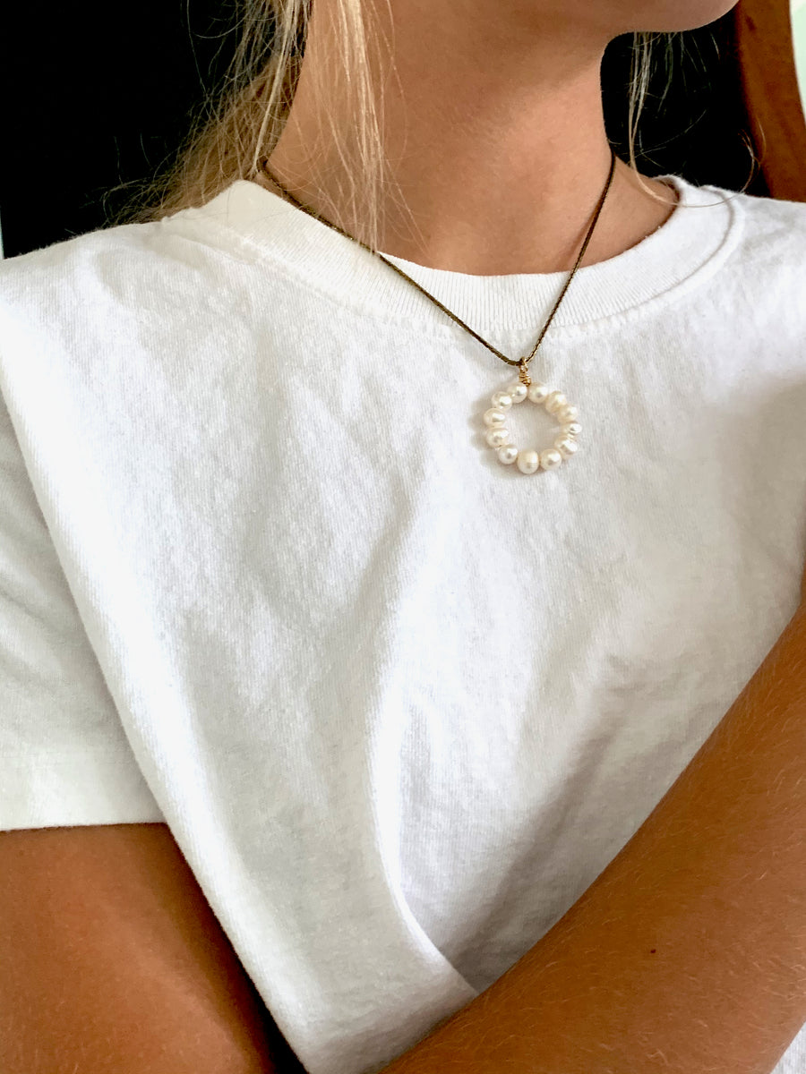 The Illuminated Necklace is a simple and elegant yet modern take on pearls. A pendant of hand wired freshwater pearls in a circular form.