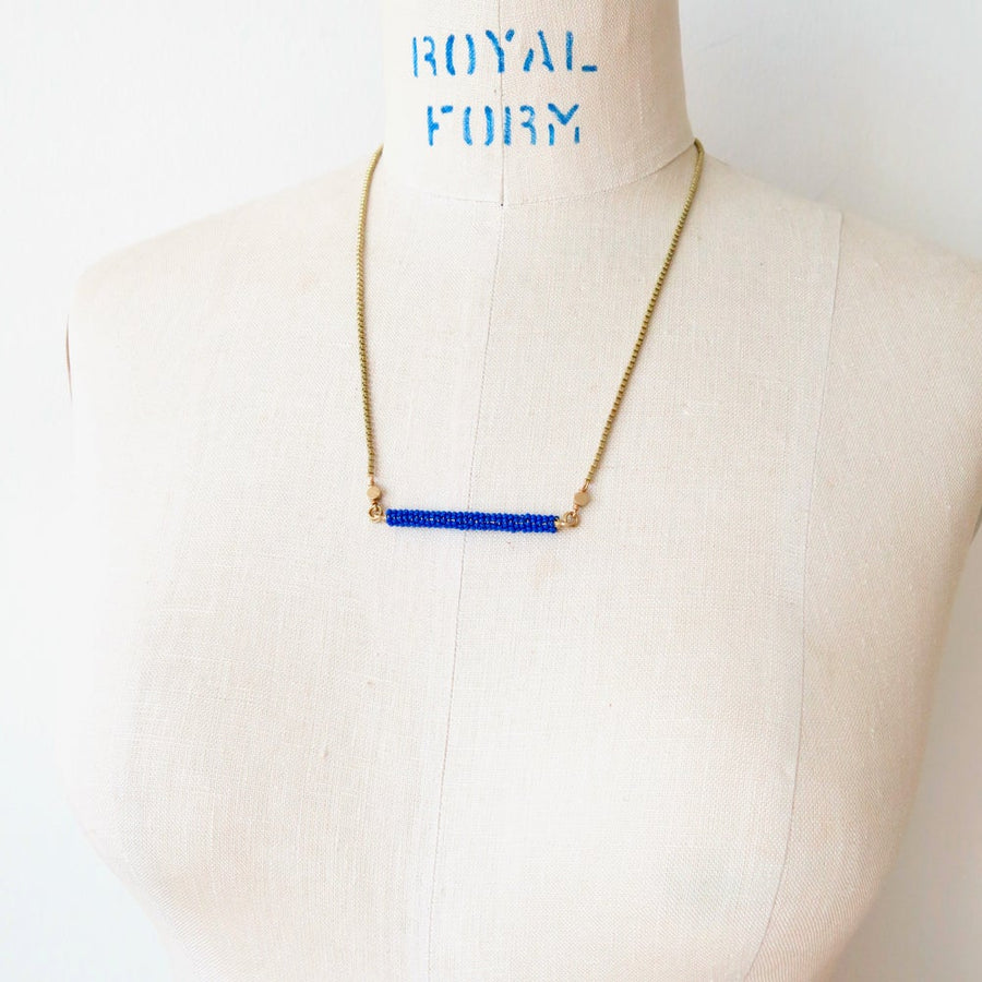 In Perfect Balance Necklace combines delicate glass beads with brass chain.