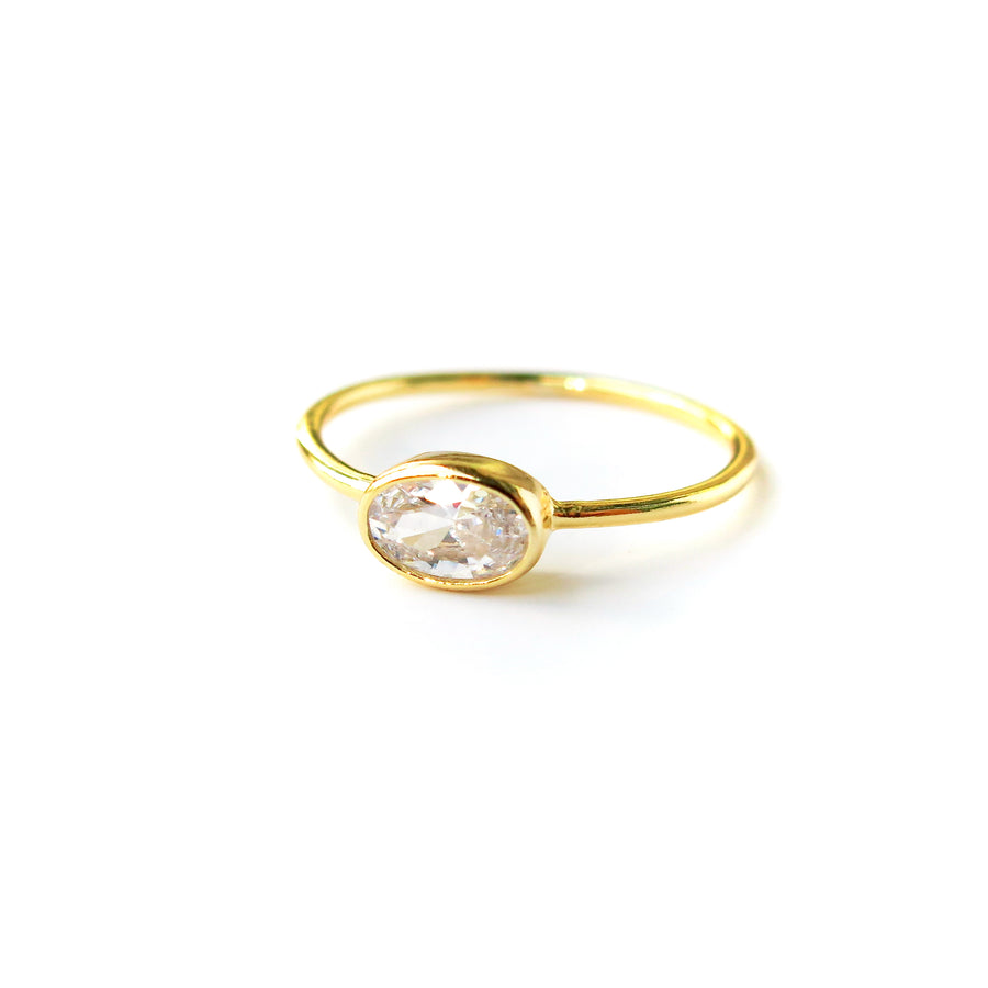 Integrity Ring with oval cubic zirconia stone set sideways on a fine band. Gold plated sterling silver.