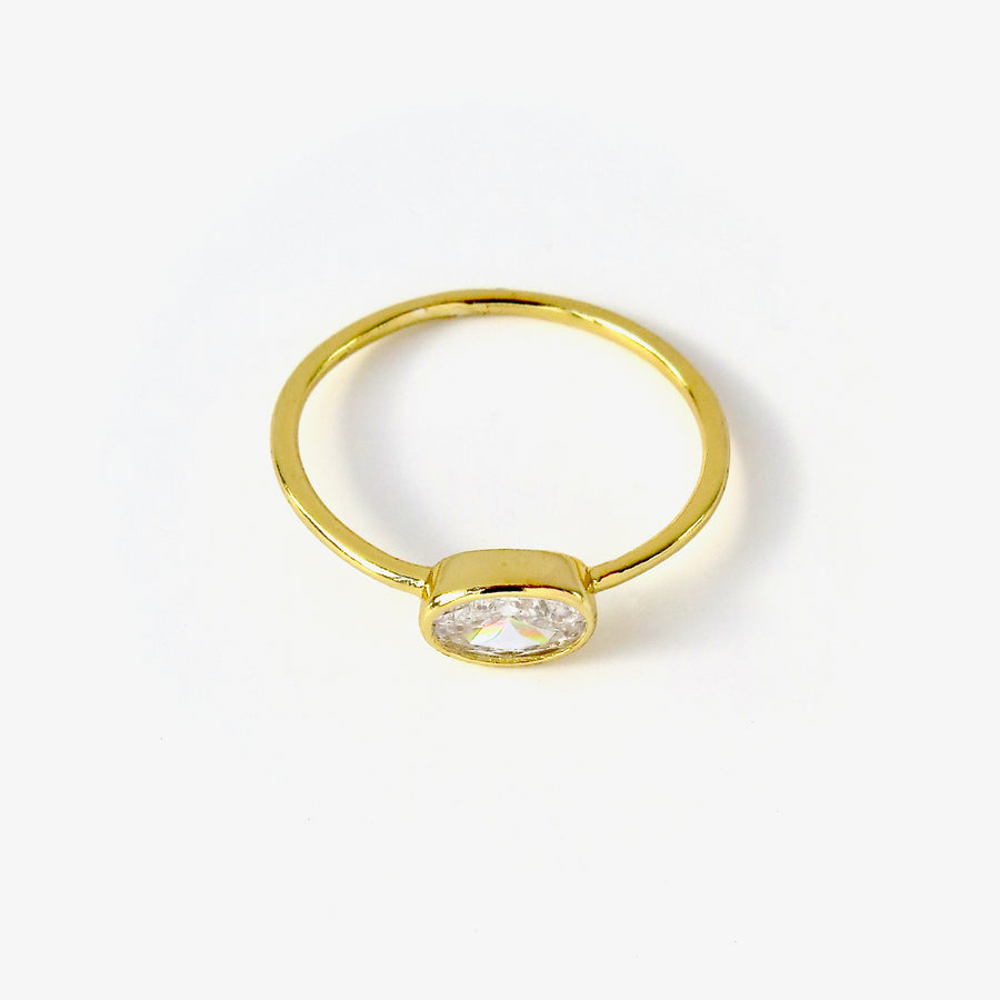 Integrity Ring with oval cubic zirconia stone set sideways on a fine band. Gold plated sterling silver.