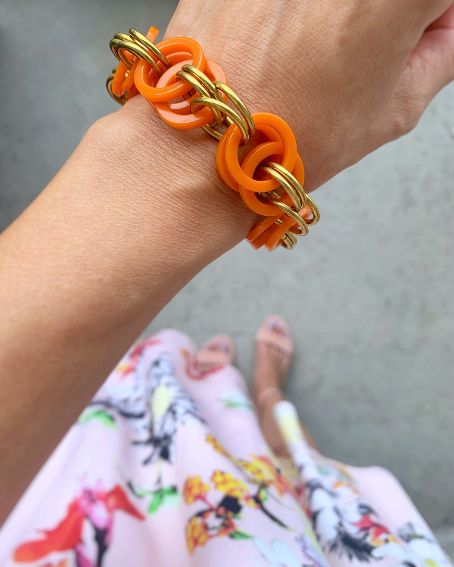 Longevity Bracelet in Orange Bakelite shown on wrist.