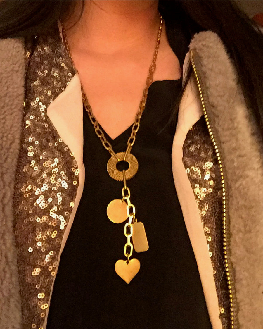 Loves Lost and Found Necklace by MoonRox Jewellery & Accessories is a brass chain lariat with charms. Shown styled with layers. 