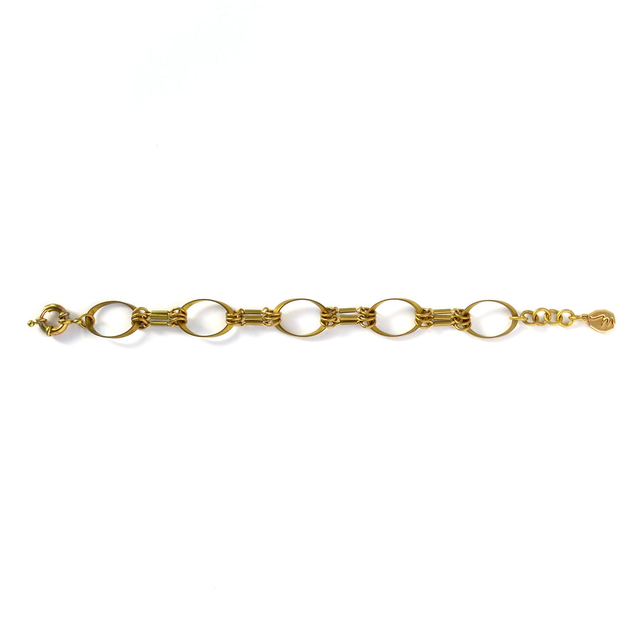 Muse Bracelet by MoonRox Jewellery & Jewellery is a brass bracelet with a mix of oval shapes and linear details.