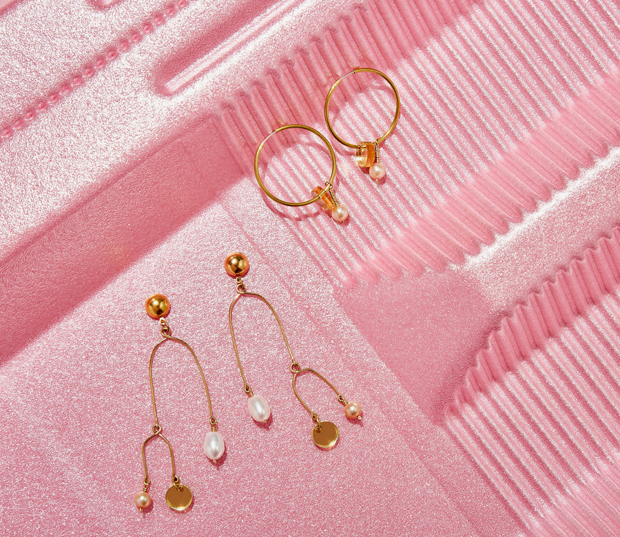 Reef Hoop Earrings are whimsical hoop earrings adorned with golden mirrored discs and pearls. Shown with the Reef Mobile Earrings.  