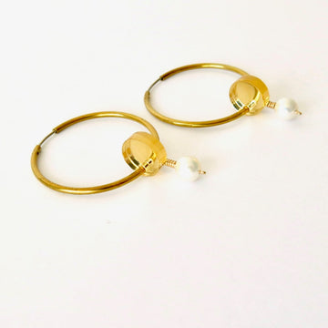 Reef Hoop Earrings are whimsical hoop earrings adorned with golden mirrored discs and pearls. Made in Toronto, Canada