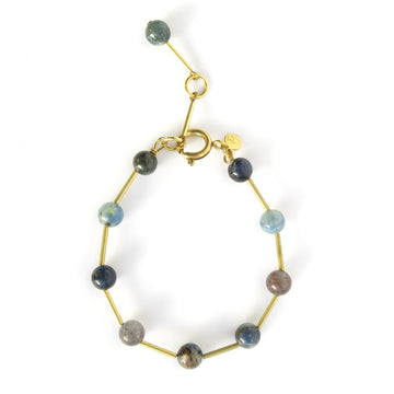 Resilience Bracelet made of round semi-precious stones staggered with brass tubes. Shown in kyanite. Made by MoonRox in Toronto, Canada.