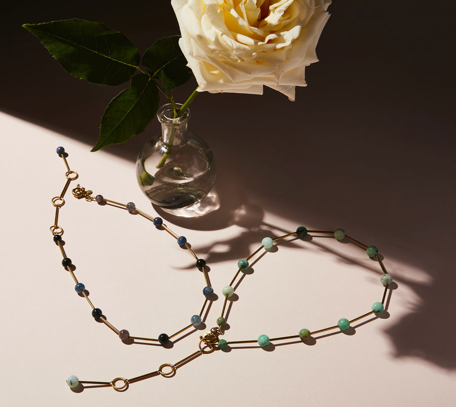 Resilience Necklace by MoonRox can be worn as a lariat or a necklace. Semi-precious stones are spaced along brass components. 