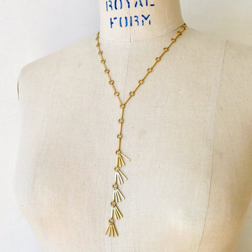 Rising Phoenix Lariat by MoonRox Jewellery & Accessories is a Y-style necklace made of brass linear components and fringe.