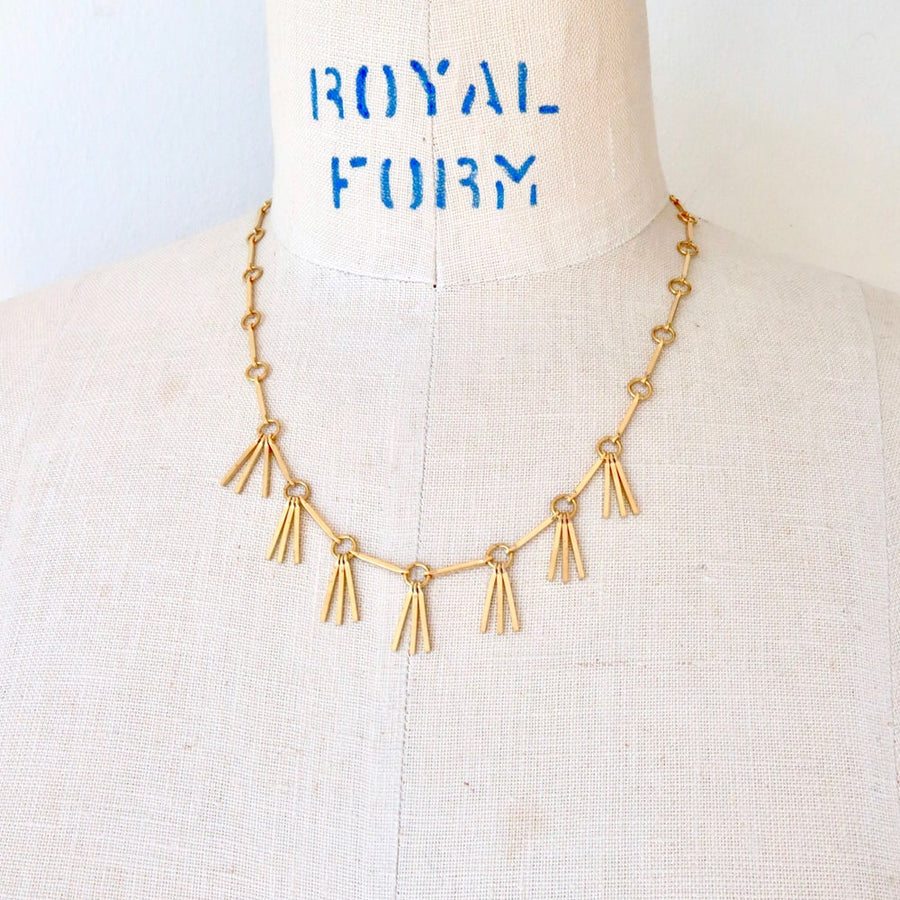 Rising Phoenix Necklace by MoonRox Jewellery & Accessories features linear components and brass fringe.