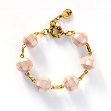 Rosa Bracelet with faceted mother of pearl beads in soft pink are hand wired together with brass links
