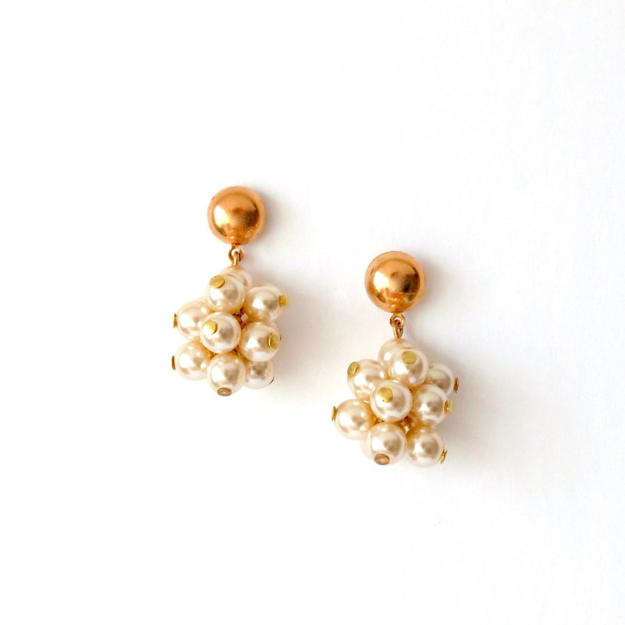 Clusters of glass pearls dangle from stud earrings.