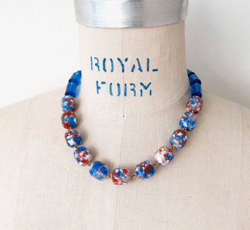 MoonRox Terrazzo Necklace with speckled acrylic beads are hand wired to blue cylindrical lucite beads.