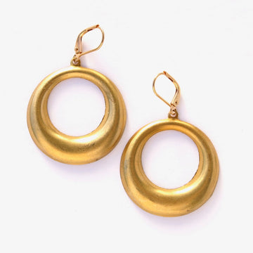 This Round's On Me Earrings by MoonRox feature circular brass charms on lever back ear wires.