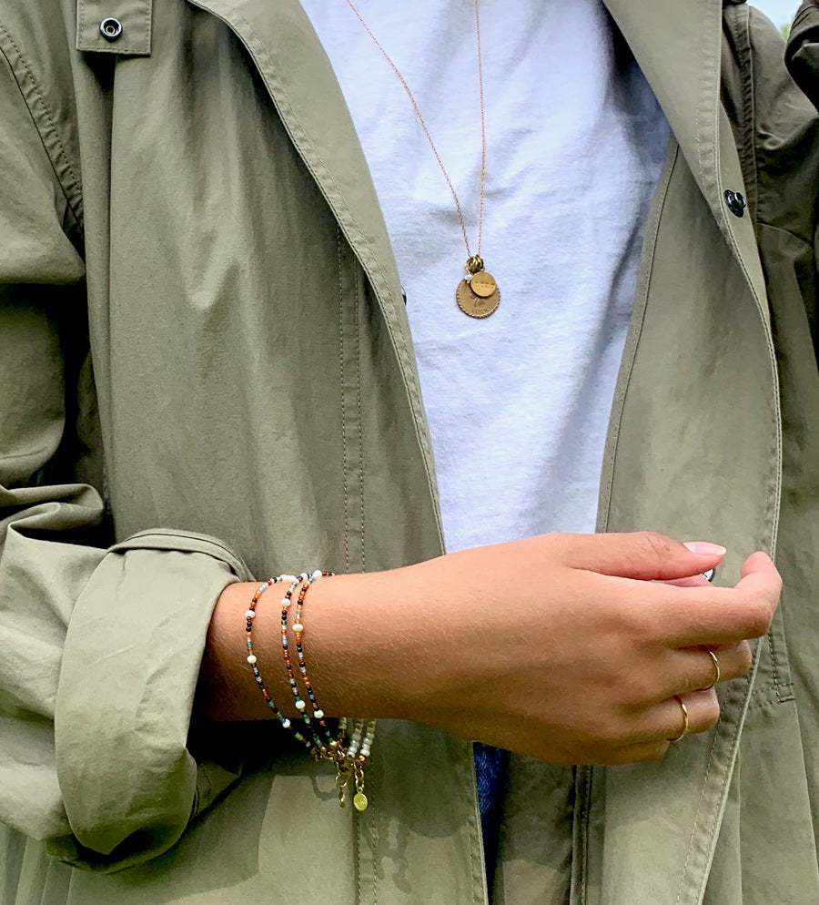 Fine Line Ring is a simple thin gold plated sterling silver band. Styled with Meridian Bracelets and Token Necklace from MoonRox Jewellery & Accessories.