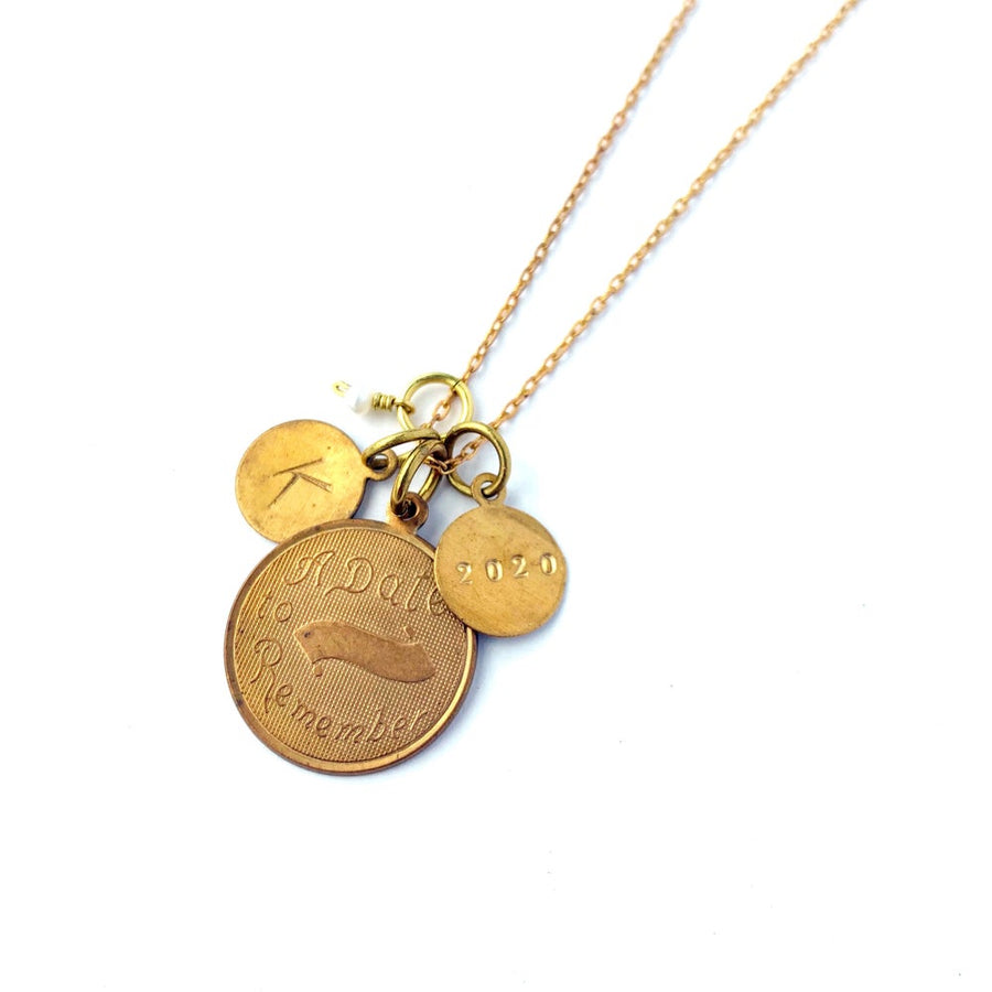 Token Necklace by MoonRox - Charm necklace with assorted coin shaped charms including one that says 