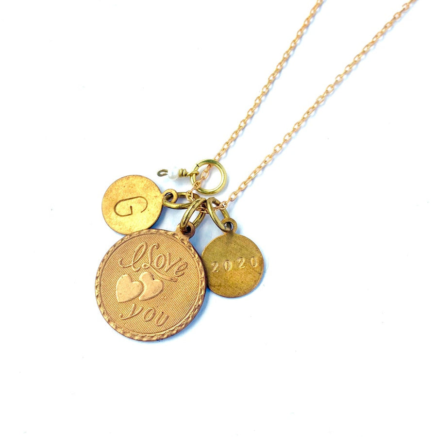 Token Necklace by MoonRox - Charm necklace with assorted coin shaped charms including one that says 