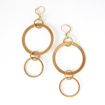 Whirlwind Earrings are large statement earrings with a mix of brass circles and loops. Made by MoonRox in Toronto, Canada.