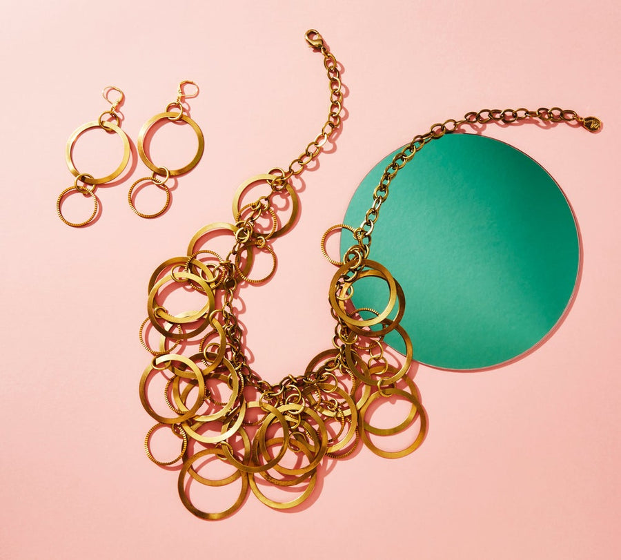 Whirlwind Necklace by MoonRox Jewellery & Accessories is a statement piece made of multiple loops and circled layered upon each other. Shown with matching earrings. Made in Toronto, Canada.