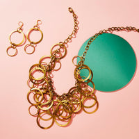 Whirlwind Earrings are large but light earrings with a mix of brass circles and loops. Shown with bold statement Whirlwind Necklace. Made by MoonRox in Toronto, Canada.