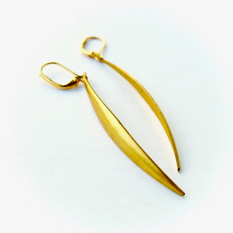 MoonRox Wisp Earrings - A narrow curved sliver of brass hangs from lever back ear wires.