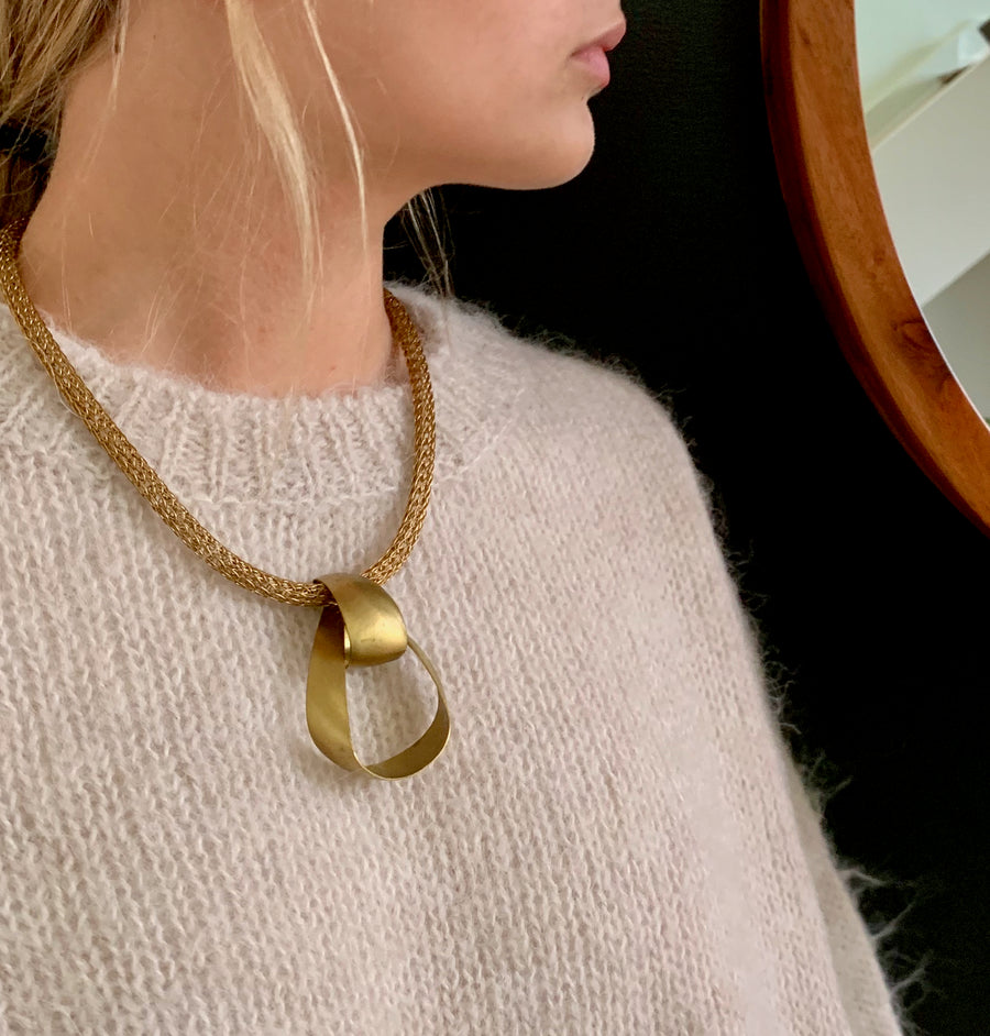 Zenith Collar by MoonRox Jewellery & Accessories - Undulating ribbon like brass pendant floats on a tubular mesh necklace.