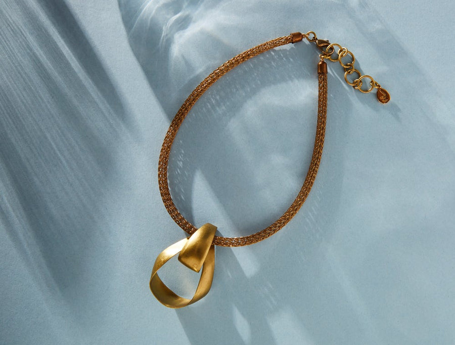 Zenith Collar by MoonRox Jewellery & Accessories - Undulating ribbon like brass pendant floats on a tubular mesh necklace.