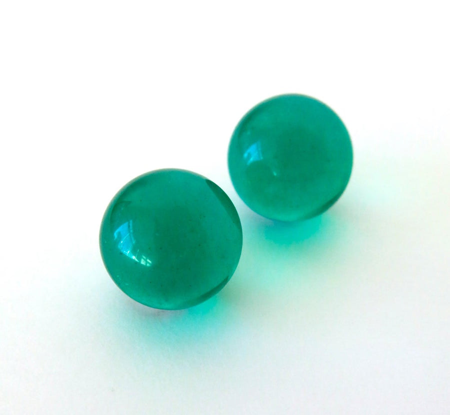 Orb Stud Earrings by MoonRox are large spherical transparent acrylic stud earrings in glowing emerald green.