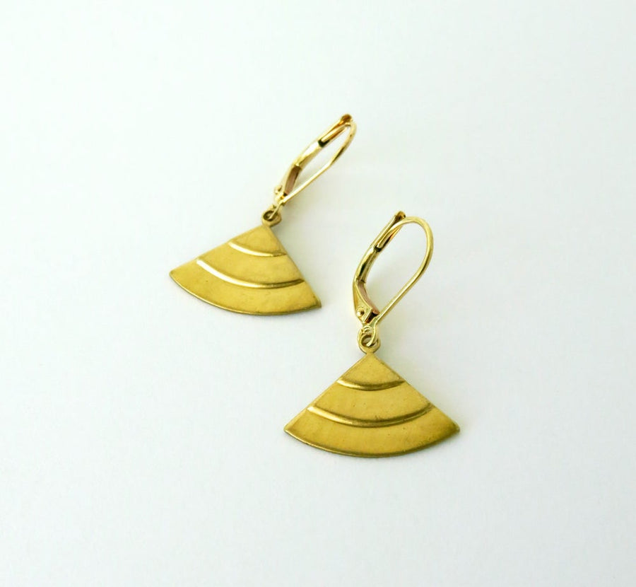 Radiant earrings feature small geometric brass charms with three stepped tiers on lever back ear wires